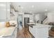 Spacious white kitchen features stainless steel appliances, large island and hardwood floors at 3000 Flat Rock Ln, Ridgeville, SC 29472