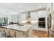 Bright, white kitchen features a large island, stainless steel appliances, and granite countertops at 3000 Flat Rock Ln, Ridgeville, SC 29472