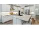 Modern kitchen with an island, stainless steel appliances, white cabinetry, and granite countertops at 3000 Flat Rock Ln, Ridgeville, SC 29472