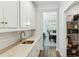 Bright kitchen features white cabinetry, granite countertops, stainless steel sink, and subway tile backsplash at 3000 Flat Rock Ln, Ridgeville, SC 29472