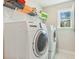 Bright laundry room with a side-by-side washer and dryer, wire rack, and window at 3000 Flat Rock Ln, Ridgeville, SC 29472