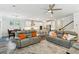 Open living room flowing into the kitchen, featuring leather sofas and wood floors at 3000 Flat Rock Ln, Ridgeville, SC 29472