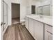 Clean bathroom with white vanity, framed mirror, walk-in shower, and wood-look flooring at 307 Sedona Dr, Summerville, SC 29486