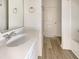 Bright bathroom with white vanity, modern fixtures, and tile flooring leading to the shower and door at 307 Sedona Dr, Summerville, SC 29486