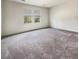 Large carpeted bedroom with two windows providing natural light and views of the outside at 307 Sedona Dr, Summerville, SC 29486