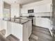 Charming kitchen features white cabinets, stainless steel appliances, granite countertops and wood style flooring at 307 Sedona Dr, Summerville, SC 29486