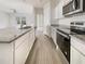 Well-lit kitchen features white cabinets, stainless steel appliances, granite countertops and wood style flooring at 307 Sedona Dr, Summerville, SC 29486