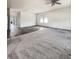 Spacious living room featuring both carpeted and hardwood flooring, large windows, and neutral walls at 307 Sedona Dr, Summerville, SC 29486