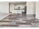 Open-concept living area boasts wood flooring and natural light, seamlessly connects to the modern kitchen at 307 Sedona Dr, Summerville, SC 29486