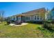 Landscaped backyard with a stone patio and grilling area, ideal for outdoor entertaining at 3668 Maidstone Dr, Mount Pleasant, SC 29466