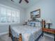Cozy bedroom with a decorative iron bed frame, shuttered windows, and beach-themed artwork at 3668 Maidstone Dr, Mount Pleasant, SC 29466