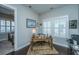 Bright home office with shuttered windows and a traditional wooden desk on a patterned rug at 3668 Maidstone Dr, Mount Pleasant, SC 29466