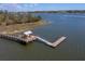 Aerial view of a dock extending into a tranquil waterway with lush surroundings at 377 Blowing Fresh Dr, Charleston, SC 29492