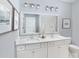 Elegant bathroom with double sinks, vanity, quartz countertops, and modern lighting at 377 Blowing Fresh Dr, Charleston, SC 29492