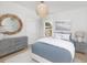 Serene bedroom with a bed, dresser, soft colors, decorative mirror, and a beach-themed picture at 377 Blowing Fresh Dr, Charleston, SC 29492