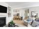 Open-concept living space with a fireplace, hardwood floors, and seamless flow to the kitchen at 377 Blowing Fresh Dr, Charleston, SC 29492