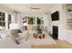 Bright living room with a fireplace, plush seating, and floor-to-ceiling windows at 377 Blowing Fresh Dr, Charleston, SC 29492