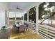 Bright and airy screened porch with table, chairs, and peaceful water views at 377 Blowing Fresh Dr, Charleston, SC 29492