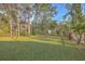 Sprawling backyard with lush green grass, mature trees, and a white picket fence at 401 Waring St, Summerville, SC 29483