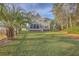 Exterior view of home's backyard featuring a grassy area and mature shade trees at 401 Waring St, Summerville, SC 29483