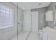 Bright bathroom with tiled shower, white vanity, and abundant natural light at 401 Waring St, Summerville, SC 29483