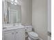 Well-lit powder room featuring a modern vanity and faucet, with a clean and simple design at 401 Waring St, Summerville, SC 29483