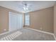 Cozy bedroom with carpet, a ceiling fan, natural light, and a spacious closet at 401 Waring St, Summerville, SC 29483