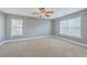 Spacious bedroom with neutral carpet, ceiling fan, and two windows providing natural light at 401 Waring St, Summerville, SC 29483