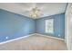 Blue bedroom with neutral carpet, ceiling fan, natural light and a double closet at 401 Waring St, Summerville, SC 29483