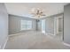 Large bedroom with carpet, ceiling fan, and multiple doorways at 401 Waring St, Summerville, SC 29483