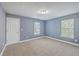 Blue bedroom with carpet flooring, natural light, and a closet for storage at 401 Waring St, Summerville, SC 29483