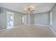 Expansive bedroom with neutral carpet, ceiling fan, and a view into the en-suite bathroom at 401 Waring St, Summerville, SC 29483