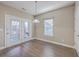 Bright dining area features white trim, hardwood floors, a pendant light and access to the outside at 401 Waring St, Summerville, SC 29483