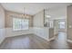 Bright dining room with elegant chandelier, large window with blinds, decorative trim, and hardwood floors at 401 Waring St, Summerville, SC 29483
