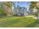 Charming two-story home with blue shutters, a front porch, a well-kept lawn, and an attached garage at 401 Waring St, Summerville, SC 29483