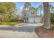 Charming two-story home with a inviting front porch, a well-kept lawn, a driveway and an attached two car garage at 401 Waring St, Summerville, SC 29483