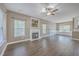Spacious living room with a fireplace, ceiling fan, beautiful hardwood floors, neutral colored walls, and natural light at 401 Waring St, Summerville, SC 29483