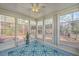 Bright sunroom with lots of windows, blue floor, and a decorative rug at 401 Waring St, Summerville, SC 29483