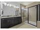 Modern bathroom featuring double vanity with granite counters and a walk-in shower with glass door at 4237 William E Murray Blvd, Charleston, SC 29414