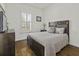 Well-lit bedroom featuring a comfortable bed, dresser, and a window with shutters at 4237 William E Murray Blvd, Charleston, SC 29414