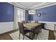 Elegant dining room with a modern light fixture and striking blue walls at 4237 William E Murray Blvd, Charleston, SC 29414