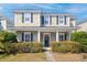 Inviting two-story home featuring a charming front porch and well-manicured landscaping at 4237 William E Murray Blvd, Charleston, SC 29414