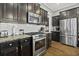 Modern kitchen with stainless steel appliances, granite countertops, and dark wood cabinets at 4237 William E Murray Blvd, Charleston, SC 29414