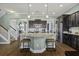 Open-concept kitchen with a large island, stainless steel appliances, and a view of the staircase at 4237 William E Murray Blvd, Charleston, SC 29414