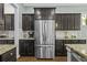 Modern kitchen with stainless steel appliances, granite countertops, and dark wood cabinets at 4237 William E Murray Blvd, Charleston, SC 29414