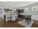 Open-concept kitchen and dining area with stainless steel appliances, granite countertops, and dark wood cabinets at 4237 William E Murray Blvd, Charleston, SC 29414