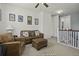 Inviting living room with leather seating, ceiling fan, and artwork on the walls at 4237 William E Murray Blvd, Charleston, SC 29414