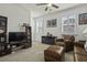 Comfortable living room with a ceiling fan and ample natural light from shuttered windows at 4237 William E Murray Blvd, Charleston, SC 29414