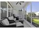 Relaxing screened-in patio with comfortable seating, perfect for enjoying the outdoors in comfort at 4237 William E Murray Blvd, Charleston, SC 29414