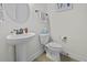 Cozy powder room featuring a pedestal sink, round mirror, and neutral wall paint at 4237 William E Murray Blvd, Charleston, SC 29414